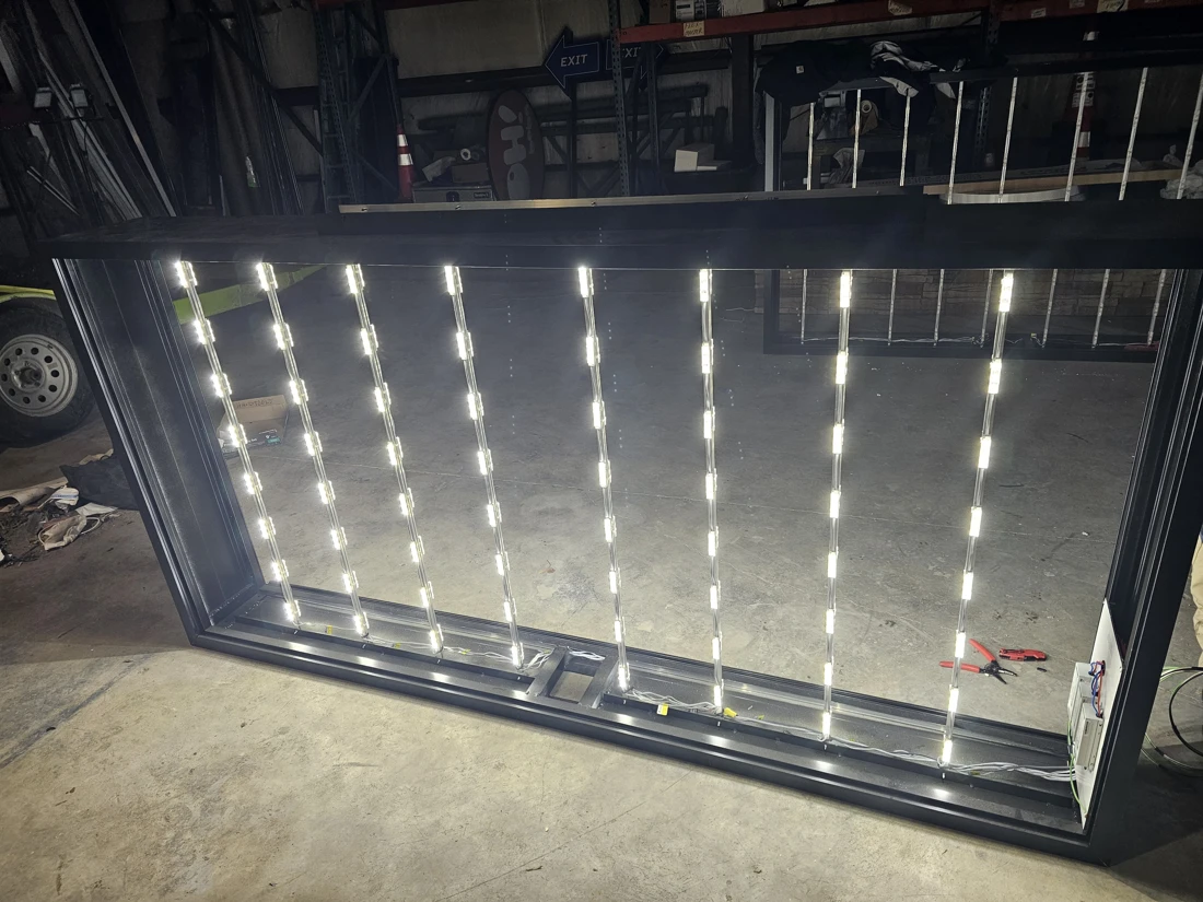 Open sign cabinet in our shop showing illuminated LED strips and internal wiring